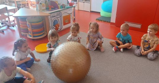 dzieci bawią się dużą piłką